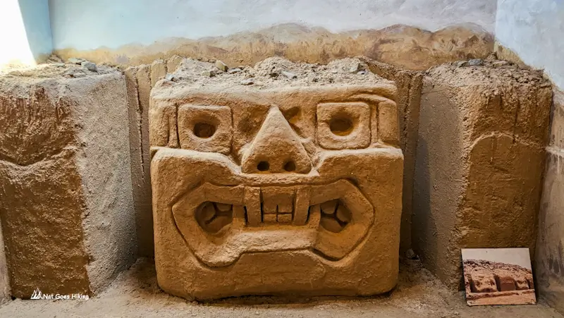 Carved Chimú face replica displayed at the Chan Chan Museum