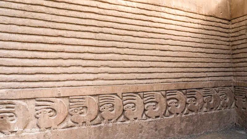 Nik An wall at Chan Chan with a row of carved sea otter motifs below plain horizontal banding