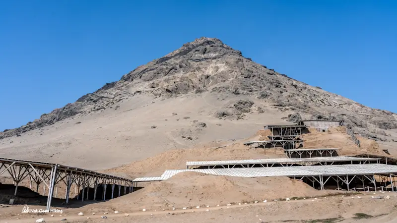 Cerro Blanco mountain rising behind the sheltered excavation platforms of Huaca de la Luna, Peru