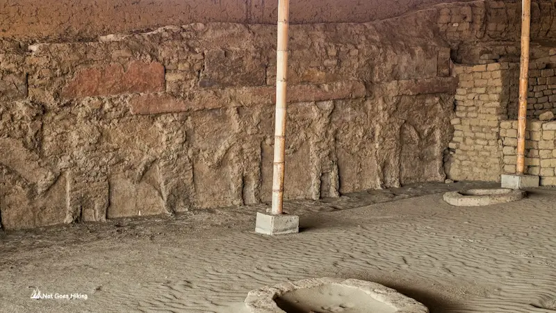 Heavily eroded adobe wall at Huaca de la Luna with faint traces of relief figures, Trujillo, Peru