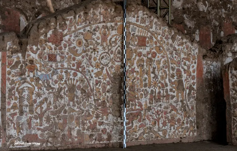 painted polychrome mural at Huaca de la Luna with mythological figures, animals and geometric motifs in red, yellow and white