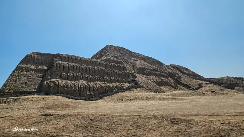 Close side view of Huaca del Sol showing eroded, striped adobe brick terraces, Trujillo, Peru