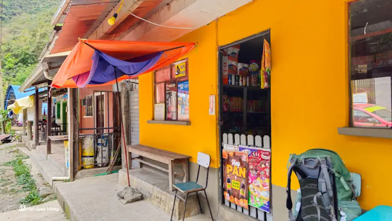 Shop with snacks on display and a backpack resting outside at the end of the El Choro Trek in Chairo